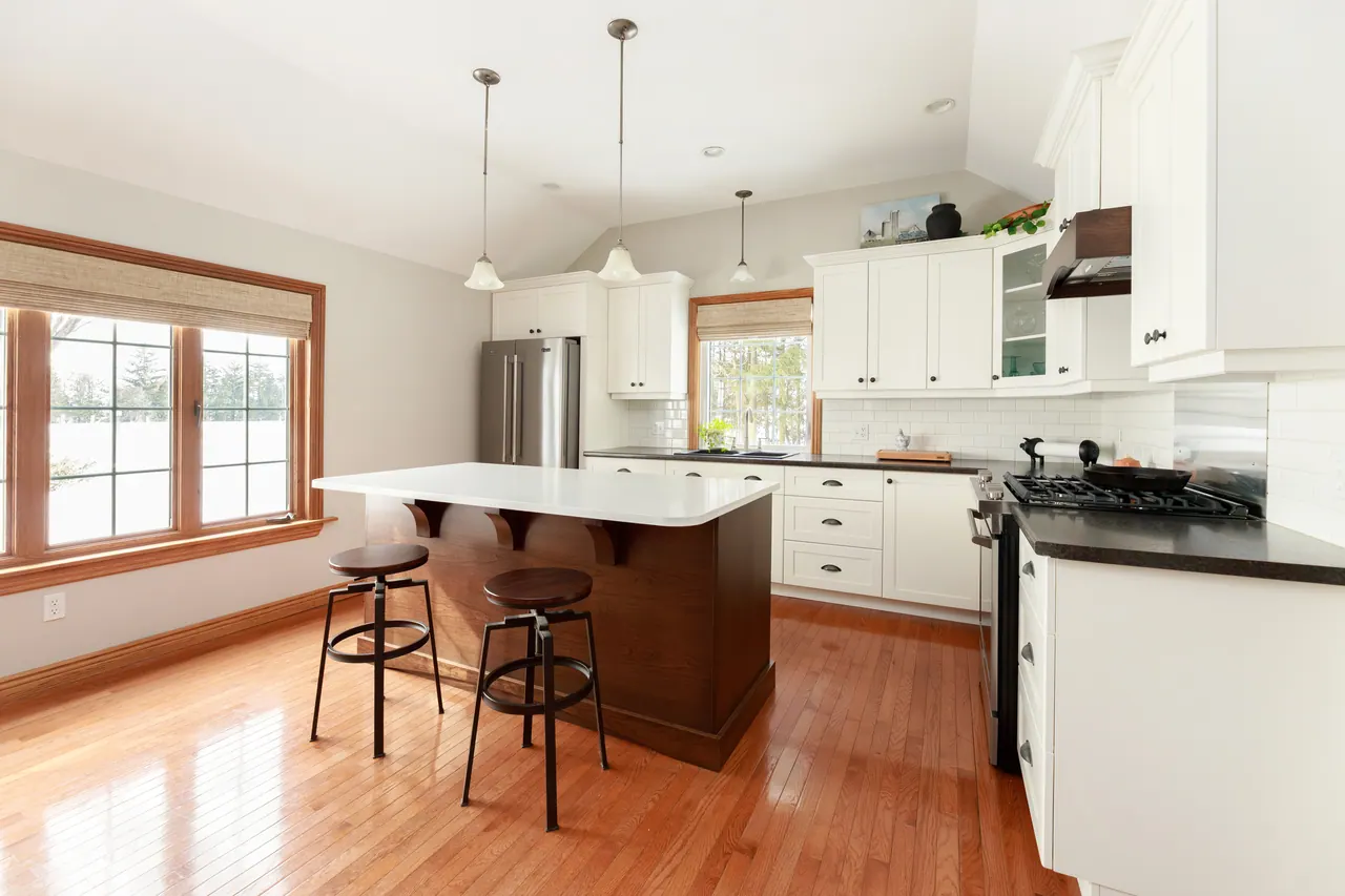 Baldoon renewed kitchen with white perimeter cabinetry and a cherry island