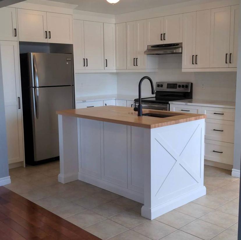 Danby Street white kitchen with a wood-topped island and X-shaped end panel