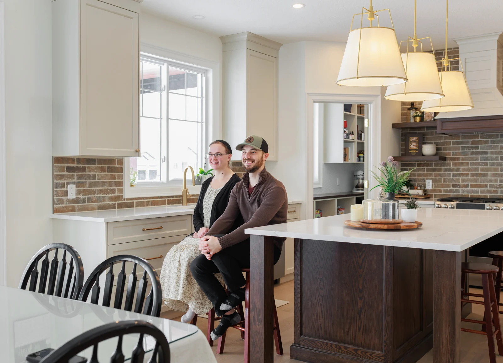 Homeowners seated beside the island in their Cranbrook kitchen