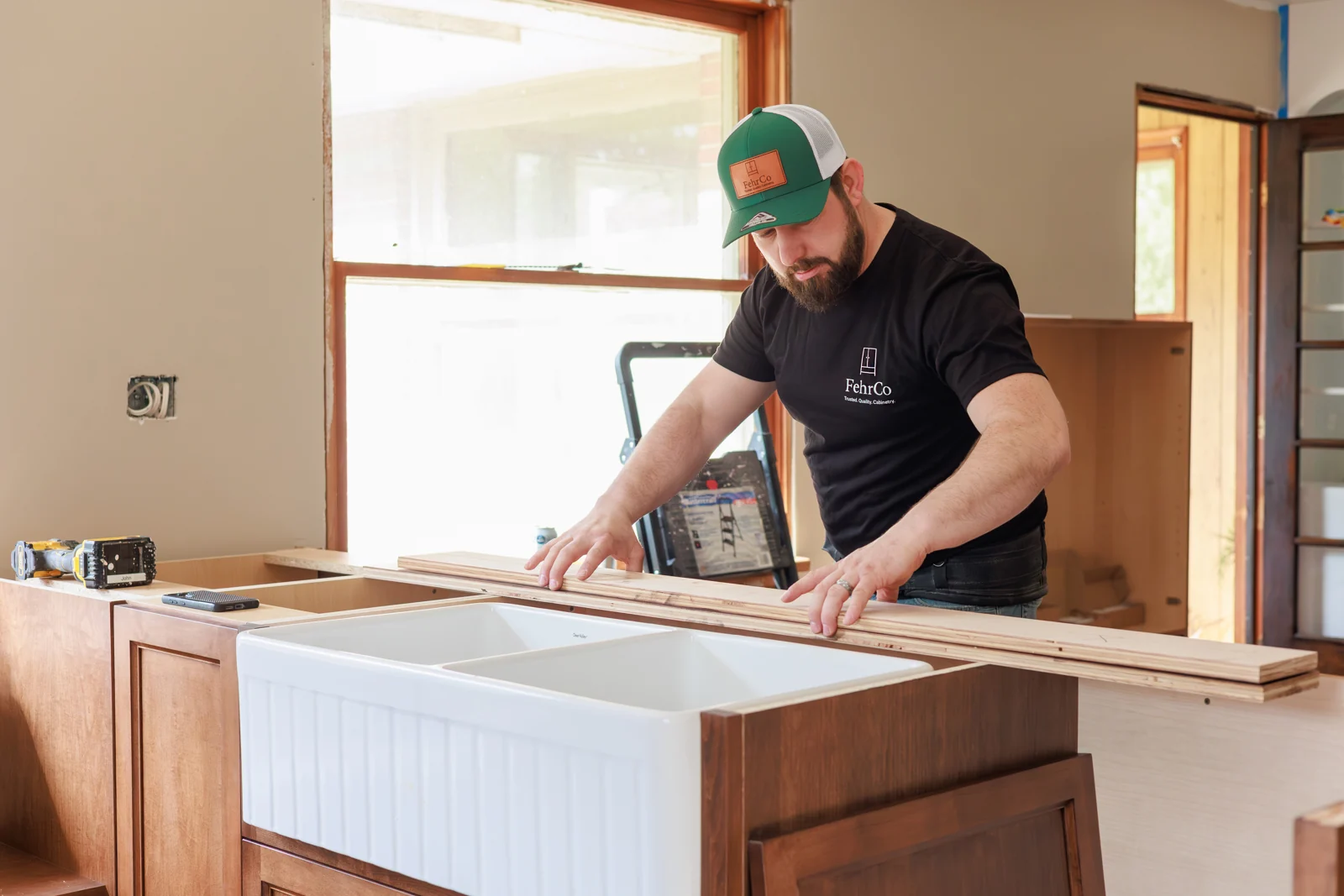 A FehrCo installer measuring at the Longwoods kitchen