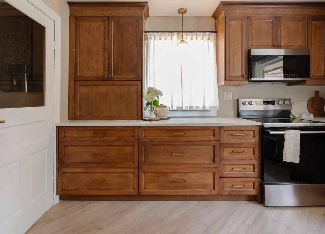 Longwoods kitchen with warm stained wood cabinets around the work area