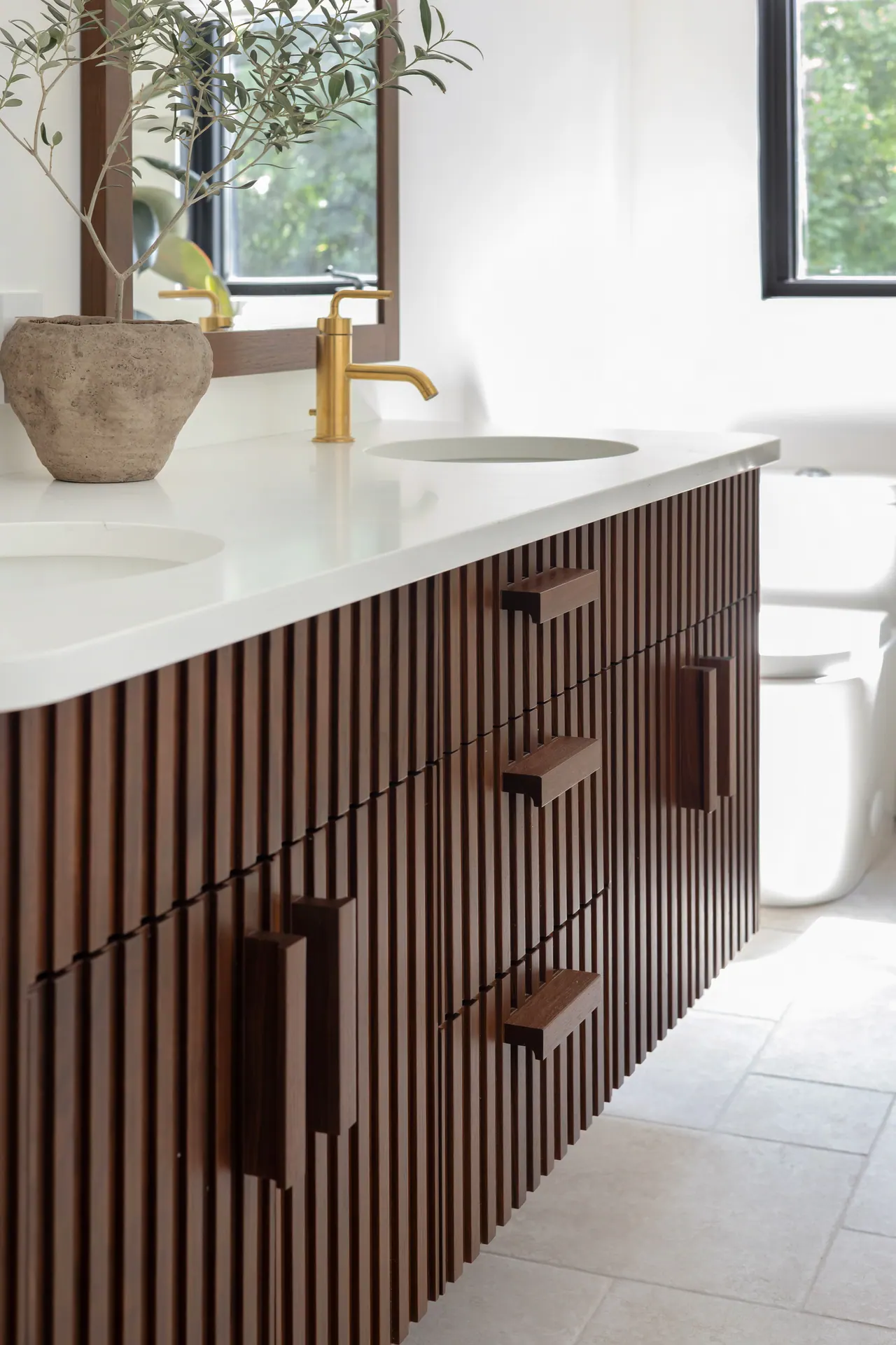 Sioux walnut double vanity with fluted fronts and integrated wooden pulls