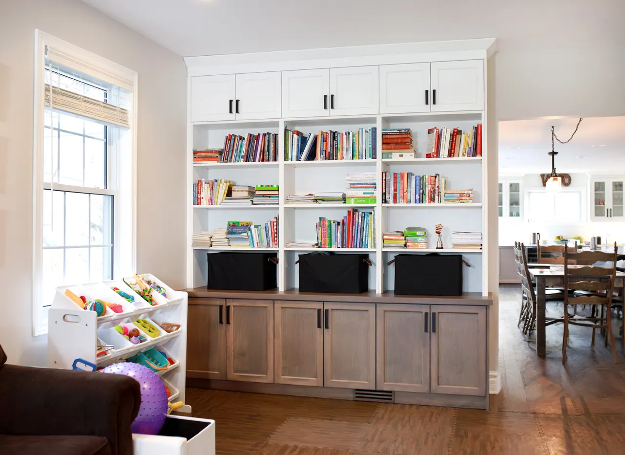 Wallaceburg floor-to-ceiling library wall with white shelves and darker lower cabinetry